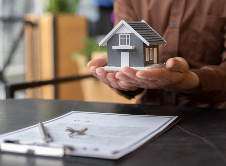 appraiser holding a small house on palm chandler az