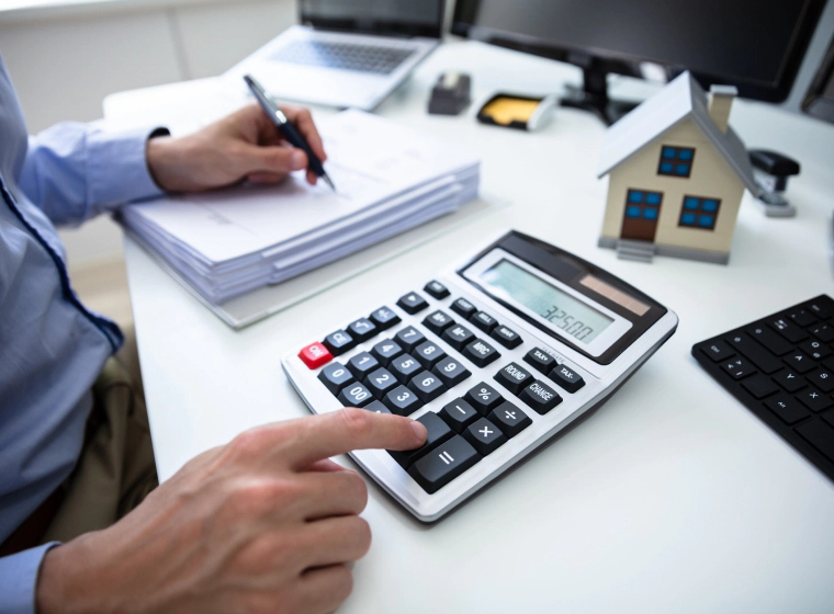 appraiser using a calculator while writing chandler az